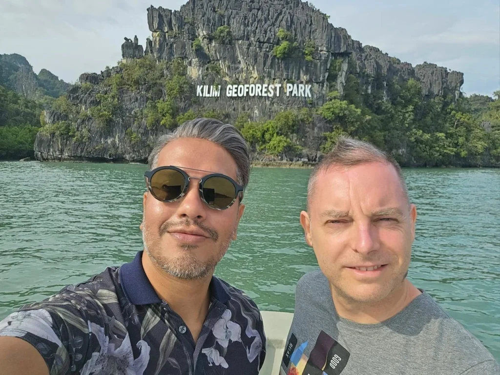 Cruising with Danny and Peter, Holland America Line, Westerdam, Porto Malai, Langkawi, Malaysia | Scenic views of Porto Malai Marina with yachts, private boat cruising through Kilim Karst Geoforest's mangroves, majestic eagles soaring above, and panoramic vistas from the Langkawi Sky Bridge and Cable Car overlooking lush rainforests and the Andaman Sea during a Langkawi Day Trip.