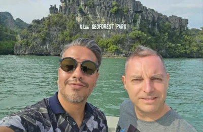 Cruising with Danny and Peter, Holland America Line, Westerdam, Porto Malai, Langkawi, Malaysia | Scenic views of Porto Malai Marina with yachts, private boat cruising through Kilim Karst Geoforest's mangroves, majestic eagles soaring above, and panoramic vistas from the Langkawi Sky Bridge and Cable Car overlooking lush rainforests and the Andaman Sea during a Langkawi Day Trip.