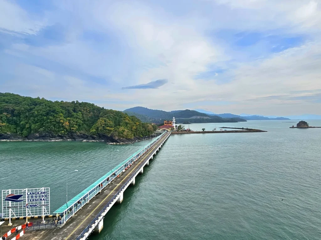 Cruising with Danny and Peter, Holland America Line, Westerdam, Porto Malai, Langkawi, Malaysia | Scenic views of Porto Malai Marina with yachts, private boat cruising through Kilim Karst Geoforest's mangroves, majestic eagles soaring above, and panoramic vistas from the Langkawi Sky Bridge and Cable Car overlooking lush rainforests and the Andaman Sea during a Langkawi Day Trip.