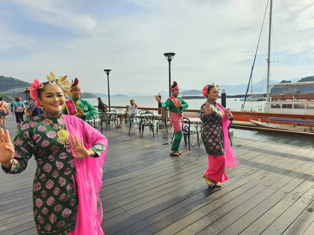 Cruising with Danny and Peter, Holland America Line, Westerdam, Porto Malai, Langkawi, Malaysia | Scenic views of Porto Malai Marina with yachts, private boat cruising through Kilim Karst Geoforest's mangroves, majestic eagles soaring above, and panoramic vistas from the Langkawi Sky Bridge and Cable Car overlooking lush rainforests and the Andaman Sea during a Langkawi Day Trip.