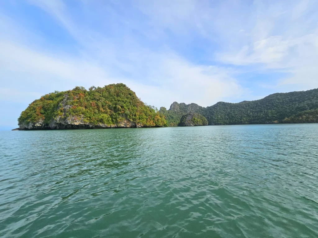 Cruising with Danny and Peter, Holland America Line, Westerdam, Porto Malai, Langkawi, Malaysia | Scenic views of Porto Malai Marina with yachts, private boat cruising through Kilim Karst Geoforest's mangroves, majestic eagles soaring above, and panoramic vistas from the Langkawi Sky Bridge and Cable Car overlooking lush rainforests and the Andaman Sea during a Langkawi Day Trip.