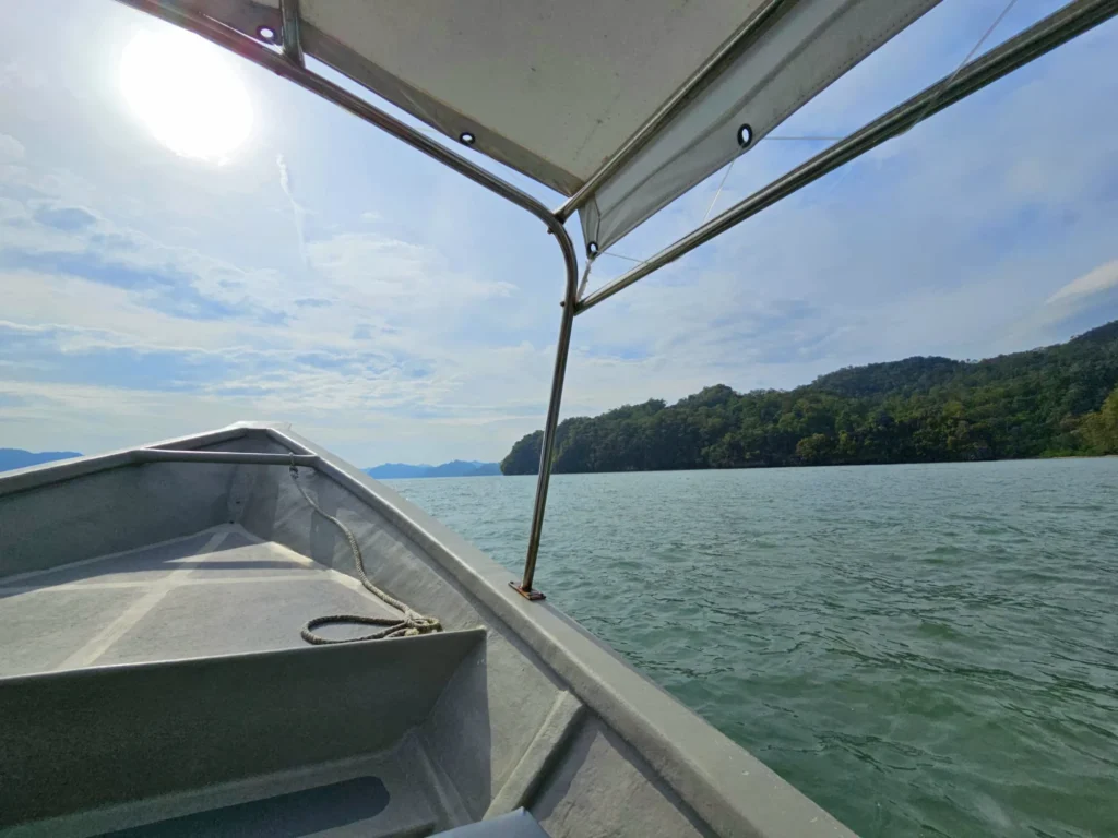 Cruising with Danny and Peter, Holland America Line, Westerdam, Porto Malai, Langkawi, Malaysia | Scenic views of Porto Malai Marina with yachts, private boat cruising through Kilim Karst Geoforest's mangroves, majestic eagles soaring above, and panoramic vistas from the Langkawi Sky Bridge and Cable Car overlooking lush rainforests and the Andaman Sea during a Langkawi Day Trip.