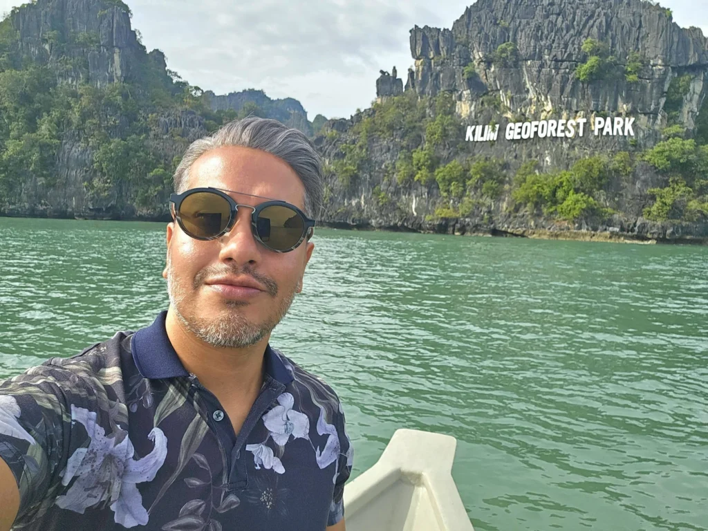 Cruising with Danny and Peter, Holland America Line, Westerdam, Porto Malai, Langkawi, Malaysia | Scenic views of Porto Malai Marina with yachts, private boat cruising through Kilim Karst Geoforest's mangroves, majestic eagles soaring above, and panoramic vistas from the Langkawi Sky Bridge and Cable Car overlooking lush rainforests and the Andaman Sea during a Langkawi Day Trip.