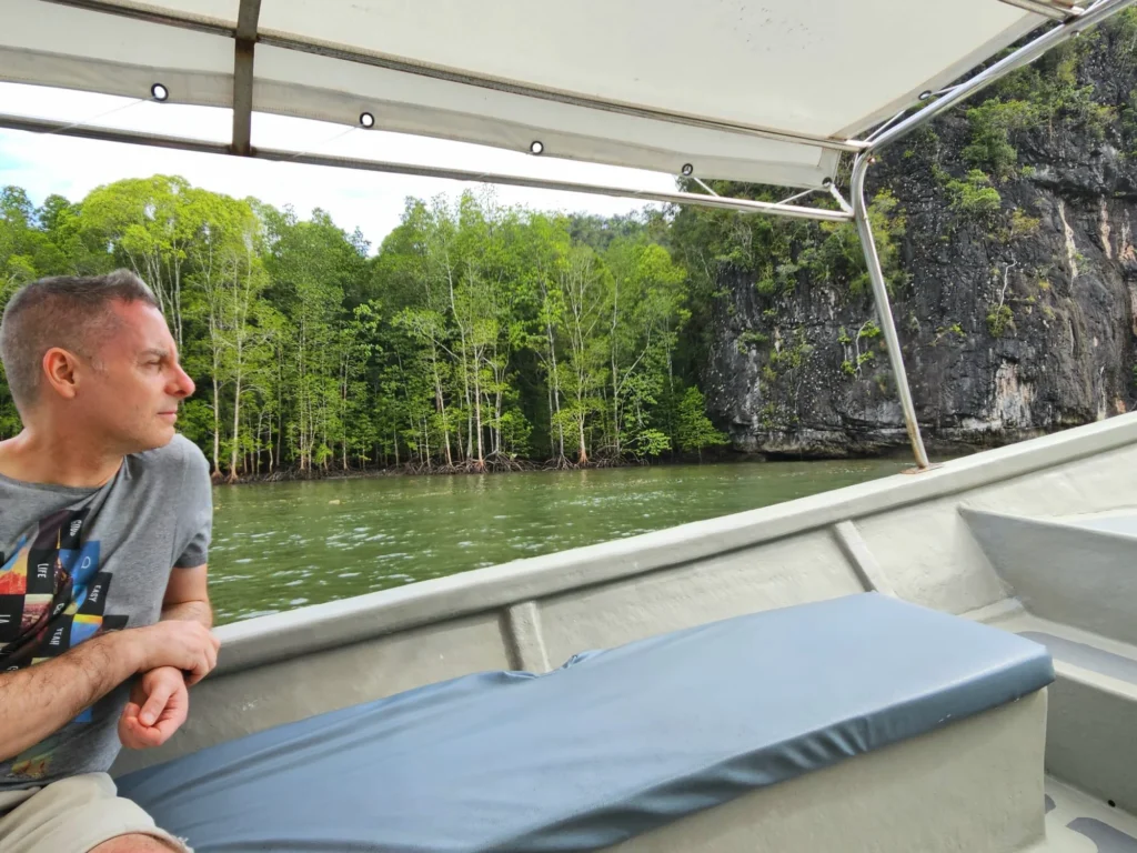 Cruising with Danny and Peter, Holland America Line, Westerdam, Porto Malai, Langkawi, Malaysia | Scenic views of Porto Malai Marina with yachts, private boat cruising through Kilim Karst Geoforest's mangroves, majestic eagles soaring above, and panoramic vistas from the Langkawi Sky Bridge and Cable Car overlooking lush rainforests and the Andaman Sea during a Langkawi Day Trip.