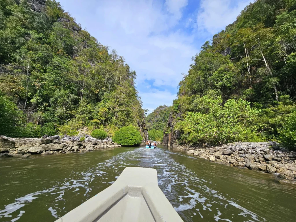 Cruising with Danny and Peter, Holland America Line, Westerdam, Porto Malai, Langkawi, Malaysia | Scenic views of Porto Malai Marina with yachts, private boat cruising through Kilim Karst Geoforest's mangroves, majestic eagles soaring above, and panoramic vistas from the Langkawi Sky Bridge and Cable Car overlooking lush rainforests and the Andaman Sea during a Langkawi Day Trip.