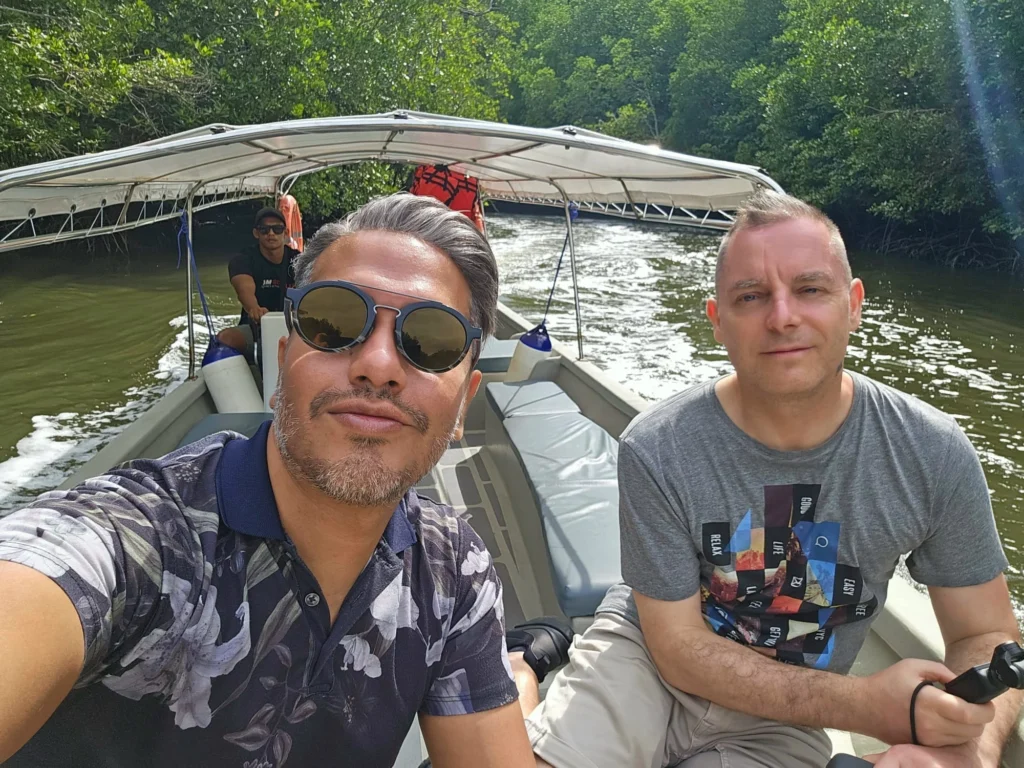 Cruising with Danny and Peter, Holland America Line, Westerdam, Porto Malai, Langkawi, Malaysia | Scenic views of Porto Malai Marina with yachts, private boat cruising through Kilim Karst Geoforest's mangroves, majestic eagles soaring above, and panoramic vistas from the Langkawi Sky Bridge and Cable Car overlooking lush rainforests and the Andaman Sea during a Langkawi Day Trip.