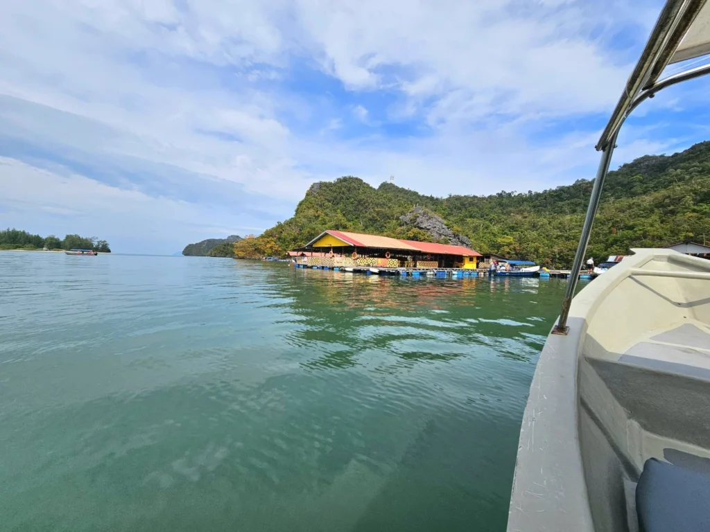 Cruising with Danny and Peter, Holland America Line, Westerdam, Porto Malai, Langkawi, Malaysia | Scenic views of Porto Malai Marina with yachts, private boat cruising through Kilim Karst Geoforest's mangroves, majestic eagles soaring above, and panoramic vistas from the Langkawi Sky Bridge and Cable Car overlooking lush rainforests and the Andaman Sea during a Langkawi Day Trip.