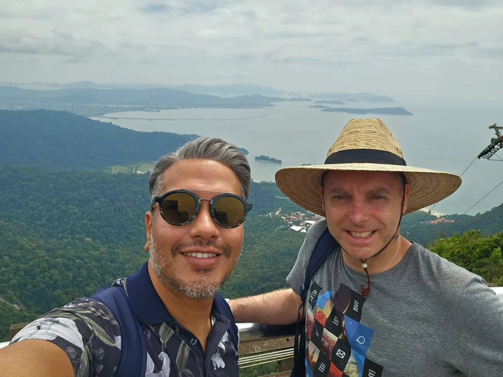 Cruising with Danny and Peter, Holland America Line, Westerdam, Porto Malai, Langkawi, Malaysia | Scenic views of Porto Malai Marina with yachts, private boat cruising through Kilim Karst Geoforest's mangroves, majestic eagles soaring above, and panoramic vistas from the Langkawi Sky Bridge and Cable Car overlooking lush rainforests and the Andaman Sea during a Langkawi Day Trip.