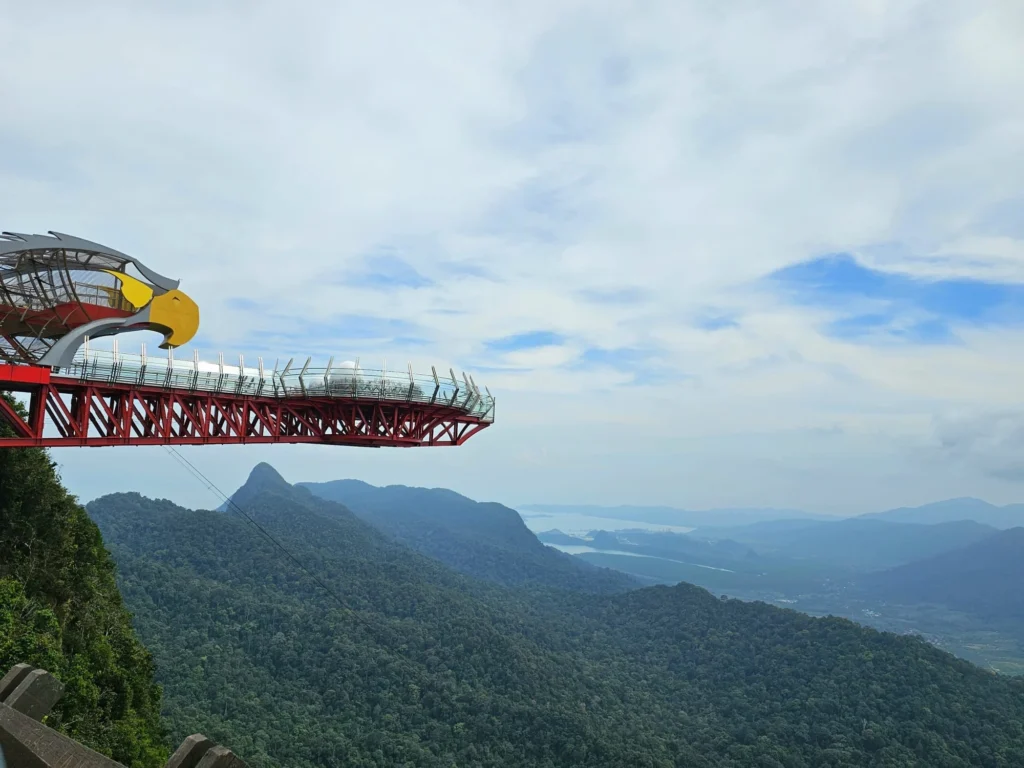 Cruising with Danny and Peter, Holland America Line, Westerdam, Porto Malai, Langkawi, Malaysia | Scenic views of Porto Malai Marina with yachts, private boat cruising through Kilim Karst Geoforest's mangroves, majestic eagles soaring above, and panoramic vistas from the Langkawi Sky Bridge and Cable Car overlooking lush rainforests and the Andaman Sea during a Langkawi Day Trip.