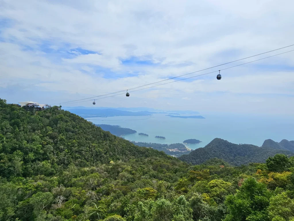 Cruising with Danny and Peter, Holland America Line, Westerdam, Porto Malai, Langkawi, Malaysia | Scenic views of Porto Malai Marina with yachts, private boat cruising through Kilim Karst Geoforest's mangroves, majestic eagles soaring above, and panoramic vistas from the Langkawi Sky Bridge and Cable Car overlooking lush rainforests and the Andaman Sea during a Langkawi Day Trip.