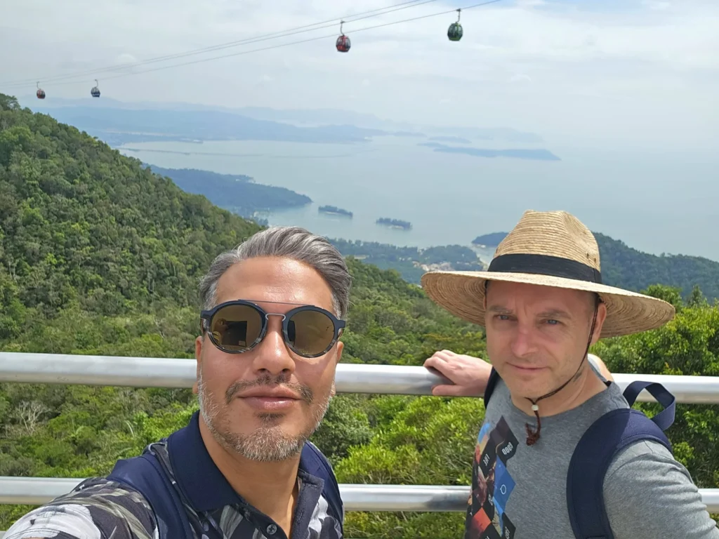 Cruising with Danny and Peter, Holland America Line, Westerdam, Porto Malai, Langkawi, Malaysia | Scenic views of Porto Malai Marina with yachts, private boat cruising through Kilim Karst Geoforest's mangroves, majestic eagles soaring above, and panoramic vistas from the Langkawi Sky Bridge and Cable Car overlooking lush rainforests and the Andaman Sea during a Langkawi Day Trip.