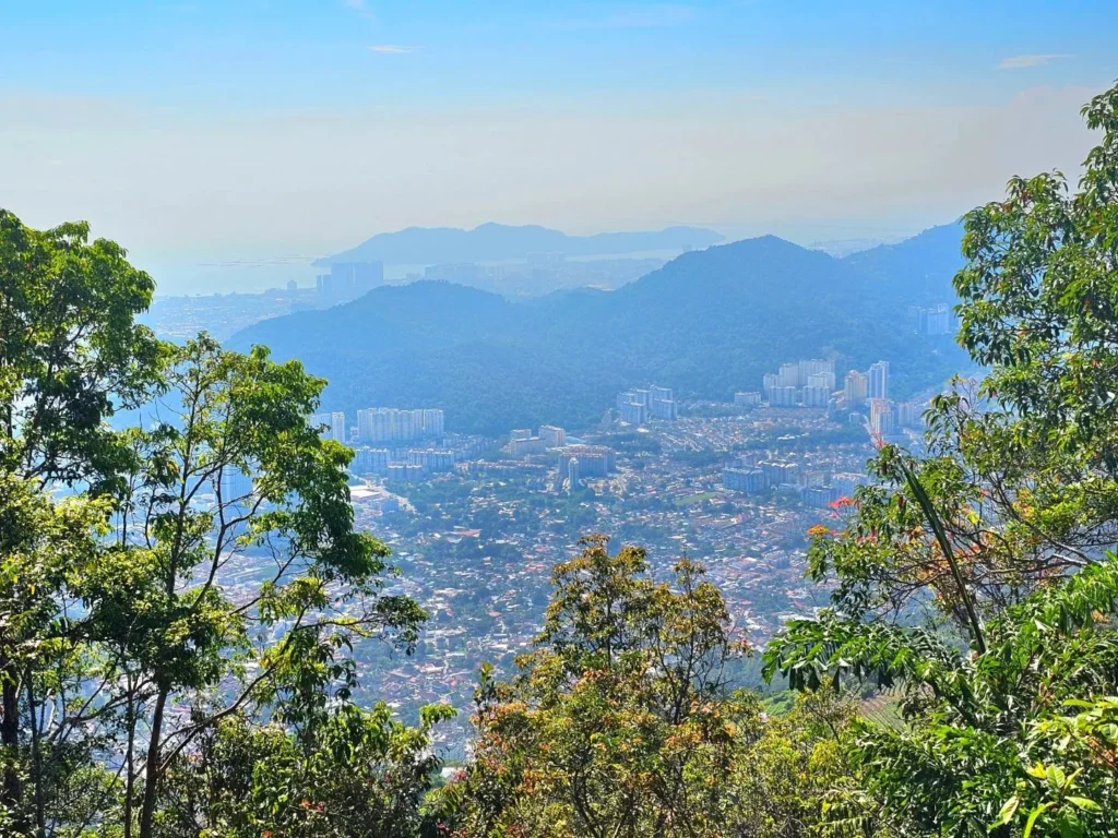 Cruising with Danny and Peter, Holland America Line, Westerdam, Penang, Malaysia | Explore Penang’s cultural treasures with the Kek Lok Si Temple’s intricate pagoda, Wat Chaiya Mangkalaram’s colossal reclining Buddha, Dhammikarama Burmese Temple’s golden structures, the ornate interior of Pinang Peranakan Mansion, the lush greenery of Penang Botanical Gardens, and the breathtaking panoramic views from Penang Hill.
