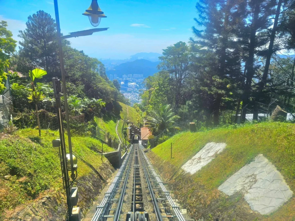 Cruising with Danny and Peter, Holland America Line, Westerdam, Penang, Malaysia | Explore Penang’s cultural treasures with the Kek Lok Si Temple’s intricate pagoda, Wat Chaiya Mangkalaram’s colossal reclining Buddha, Dhammikarama Burmese Temple’s golden structures, the ornate interior of Pinang Peranakan Mansion, the lush greenery of Penang Botanical Gardens, and the breathtaking panoramic views from Penang Hill.