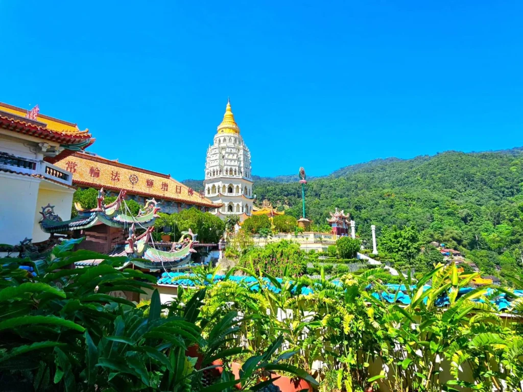 Cruising with Danny and Peter, Holland America Line, Westerdam, Penang, Malaysia | Explore Penang’s cultural treasures with the Kek Lok Si Temple’s intricate pagoda, Wat Chaiya Mangkalaram’s colossal reclining Buddha, Dhammikarama Burmese Temple’s golden structures, the ornate interior of Pinang Peranakan Mansion, the lush greenery of Penang Botanical Gardens, and the breathtaking panoramic views from Penang Hill.