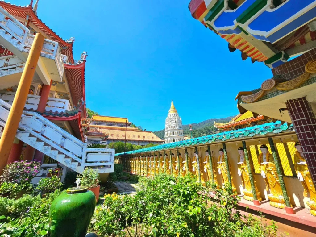 Cruising with Danny and Peter, Holland America Line, Westerdam, Penang, Malaysia | Explore Penang’s cultural treasures with the Kek Lok Si Temple’s intricate pagoda, Wat Chaiya Mangkalaram’s colossal reclining Buddha, Dhammikarama Burmese Temple’s golden structures, the ornate interior of Pinang Peranakan Mansion, the lush greenery of Penang Botanical Gardens, and the breathtaking panoramic views from Penang Hill.