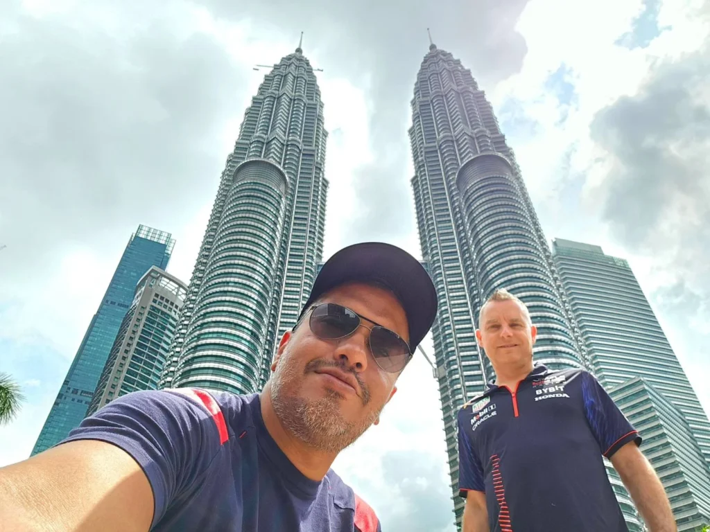 Cruising with Danny and Peter, Holland America Line, Westerdam, Port Kelang, Kuala Lumpur, Malaysia | Port Klang harbor bustling with cargo ships, vibrant staircase leading up to Batu Caves with colorful Hindu art, iconic Petronas Twin Towers towering over Kuala Lumpur’s skyline, panoramic view from KL Tower observation deck showcasing the cityscape, and historical artifacts at the National Museum illustrating Malaysia’s cultural heritage.