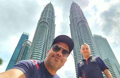 Cruising with Danny and Peter, Holland America Line, Westerdam, Port Kelang, Kuala Lumpur, Malaysia | Port Klang harbor bustling with cargo ships, vibrant staircase leading up to Batu Caves with colorful Hindu art, iconic Petronas Twin Towers towering over Kuala Lumpur’s skyline, panoramic view from KL Tower observation deck showcasing the cityscape, and historical artifacts at the National Museum illustrating Malaysia’s cultural heritage.