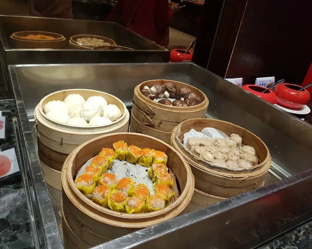 Keelung Taipei Cruise Port: Our Complete Guide + Insider Tips 2026 (Visited Once in 2019 by Danny and Peter) 20 Cruising with Danny and Peter, Holland America Line, Westerdam, Keelung, Taipei, Taiwan | Vibrant scene of Keelung Night Market showcasing diverse Taiwanese street food, including oyster pancakes and stinky tofu, with colorful stalls and lively crowds. Scenic views from Chaojing Park overlooking Keelung Harbor, featuring traditional architecture and lush landscapes. Picturesque images of Keelung Island attractions, highlighting pristine beaches and charming fishing villages, capturing the cultural heritage of Keelung and its rich maritime history.