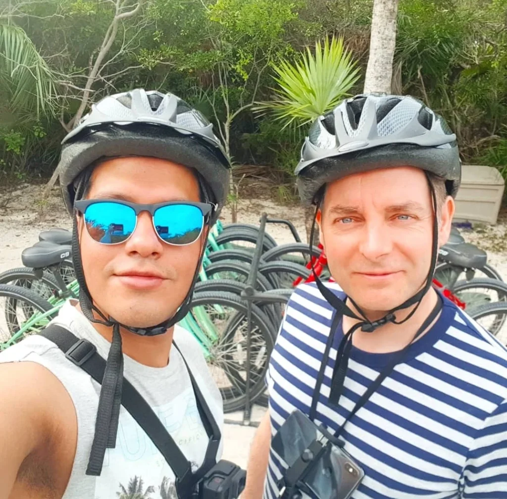 A Slice of Paradise: Experience the Bahamas Beach Paradise of Half Moon Cay 2 Cruising with Danny and Peter, Holland America Line, Zuiderdam, Half Moon Cay, Bahamas | Stunning view of Half Moon Cay showcasing its pristine sandy shores, vibrant turquoise waters, and swaying palm trees, epitomizing a Bahamas beach paradise. Visitors enjoy exciting water activities like kayaking and jet skiing, while others relax on sun-soaked beaches, capturing the essence of this tropical island paradise.