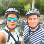 Cruising with Danny and Peter, Holland America Line, Zuiderdam, Half Moon Cay, Bahamas | Stunning view of Half Moon Cay showcasing its pristine sandy shores, vibrant turquoise waters, and swaying palm trees, epitomizing a Bahamas beach paradise. Visitors enjoy exciting water activities like kayaking and jet skiing, while others relax on sun-soaked beaches, capturing the essence of this tropical island paradise.