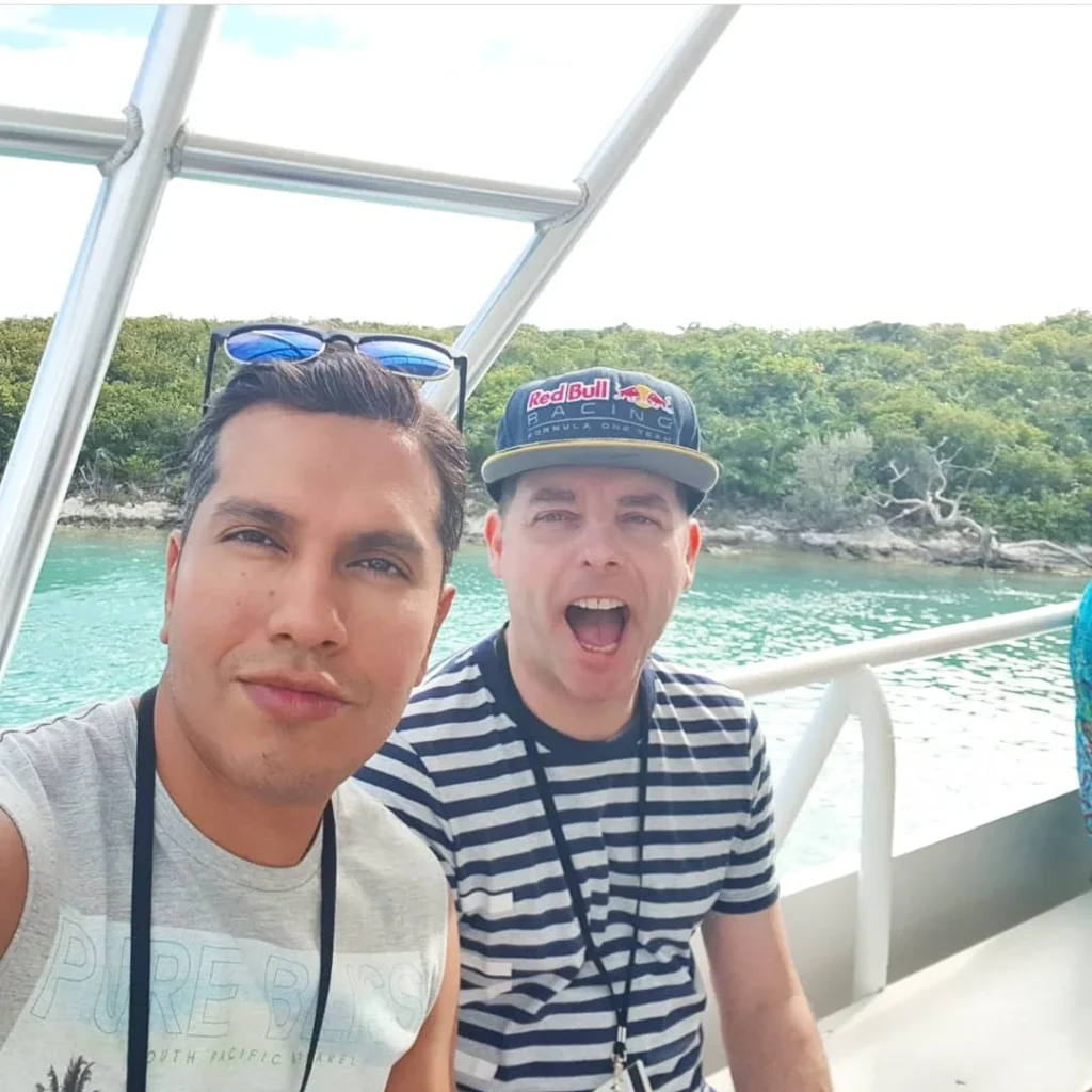 A Slice of Paradise: Experience the Bahamas Beach Paradise of Half Moon Cay 4 Cruising with Danny and Peter, Holland America Line, Zuiderdam, Half Moon Cay, Bahamas | Stunning view of Half Moon Cay showcasing its pristine sandy shores, vibrant turquoise waters, and swaying palm trees, epitomizing a Bahamas beach paradise. Visitors enjoy exciting water activities like kayaking and jet skiing, while others relax on sun-soaked beaches, capturing the essence of this tropical island paradise.