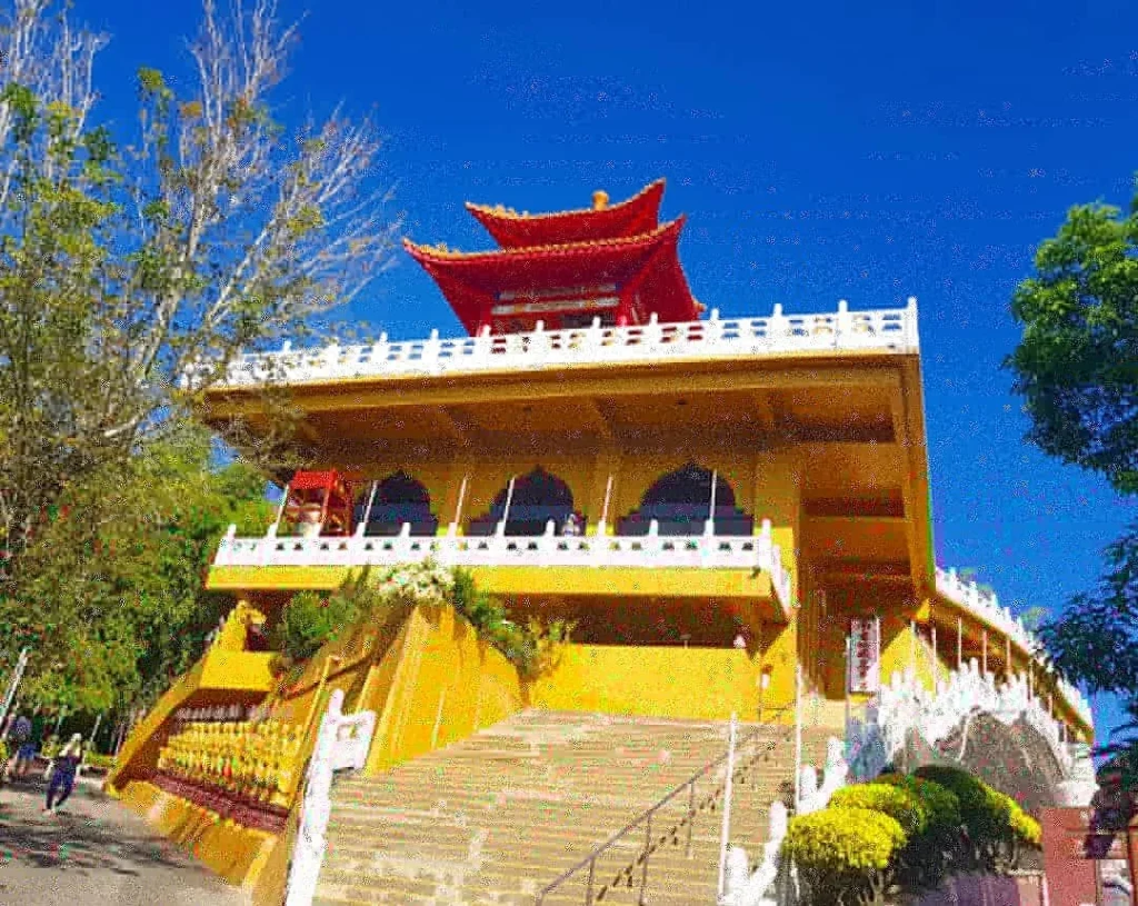 Cruising with Danny and Peter, Holland America Line, Westerdam, Kaohsiung, Taiwan | A serene Buddhist temple in Kaohsiung, showcasing intricate artwork and vibrant colors, representing the city's cultural heritage; beautiful views of Lotus Lake with picturesque pagodas and blooming lotus flowers, capturing the stunning natural landscapes; a bustling street food market with vendors offering local delicacies, highlighting Kaohsiung's vibrant local cuisine and inviting visitors to join a memorable street food tour.