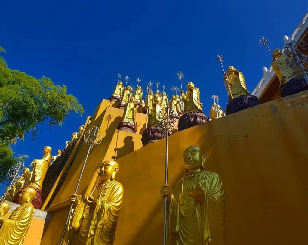 Cruising with Danny and Peter, Holland America Line, Westerdam, Kaohsiung, Taiwan | A serene Buddhist temple in Kaohsiung, showcasing intricate artwork and vibrant colors, representing the city's cultural heritage; beautiful views of Lotus Lake with picturesque pagodas and blooming lotus flowers, capturing the stunning natural landscapes; a bustling street food market with vendors offering local delicacies, highlighting Kaohsiung's vibrant local cuisine and inviting visitors to join a memorable street food tour.