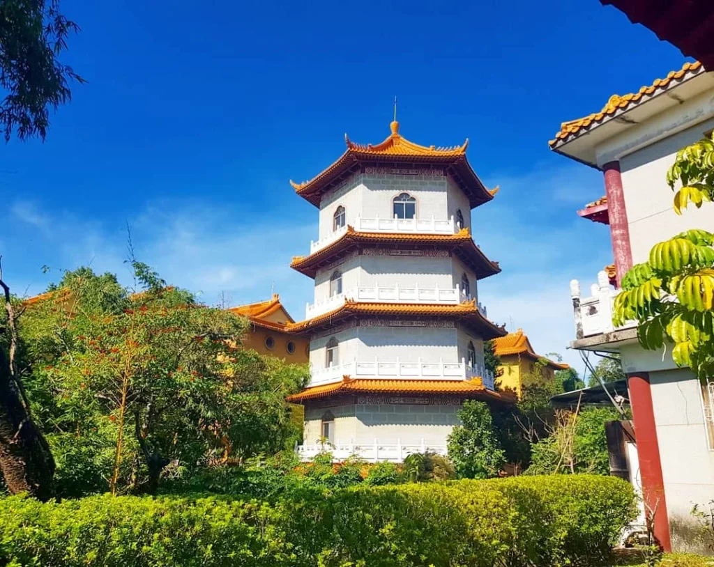 Cruising with Danny and Peter, Holland America Line, Westerdam, Kaohsiung, Taiwan | A serene Buddhist temple in Kaohsiung, showcasing intricate artwork and vibrant colors, representing the city's cultural heritage; beautiful views of Lotus Lake with picturesque pagodas and blooming lotus flowers, capturing the stunning natural landscapes; a bustling street food market with vendors offering local delicacies, highlighting Kaohsiung's vibrant local cuisine and inviting visitors to join a memorable street food tour.