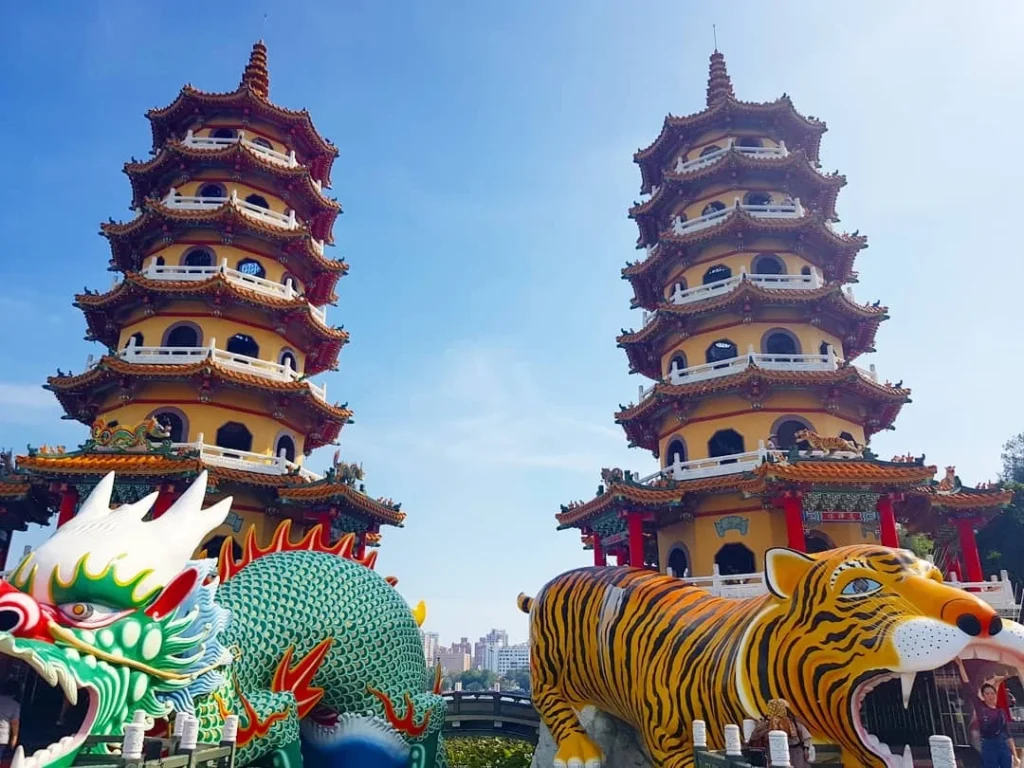 Cruising with Danny and Peter, Holland America Line, Westerdam, Kaohsiung, Taiwan | A serene Buddhist temple in Kaohsiung, showcasing intricate artwork and vibrant colors, representing the city's cultural heritage; beautiful views of Lotus Lake with picturesque pagodas and blooming lotus flowers, capturing the stunning natural landscapes; a bustling street food market with vendors offering local delicacies, highlighting Kaohsiung's vibrant local cuisine and inviting visitors to join a memorable street food tour.