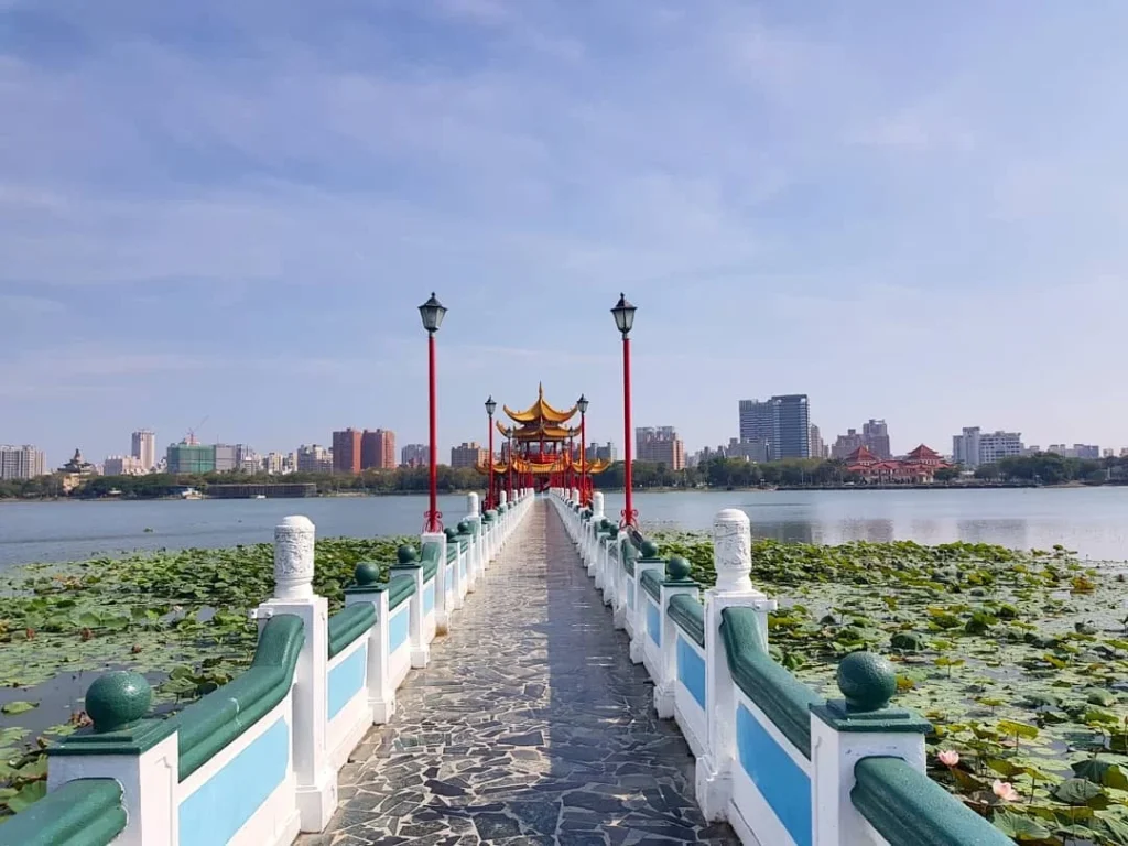 Cruising with Danny and Peter, Holland America Line, Westerdam, Kaohsiung, Taiwan | A serene Buddhist temple in Kaohsiung, showcasing intricate artwork and vibrant colors, representing the city's cultural heritage; beautiful views of Lotus Lake with picturesque pagodas and blooming lotus flowers, capturing the stunning natural landscapes; a bustling street food market with vendors offering local delicacies, highlighting Kaohsiung's vibrant local cuisine and inviting visitors to join a memorable street food tour.