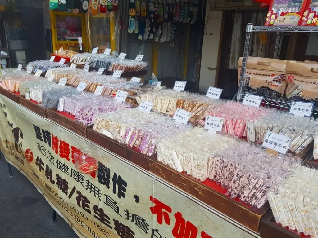 Cruising with Danny and Peter, Holland America Line, Westerdam, Kaohsiung, Taiwan | A serene Buddhist temple in Kaohsiung, showcasing intricate artwork and vibrant colors, representing the city's cultural heritage; beautiful views of Lotus Lake with picturesque pagodas and blooming lotus flowers, capturing the stunning natural landscapes; a bustling street food market with vendors offering local delicacies, highlighting Kaohsiung's vibrant local cuisine and inviting visitors to join a memorable street food tour.