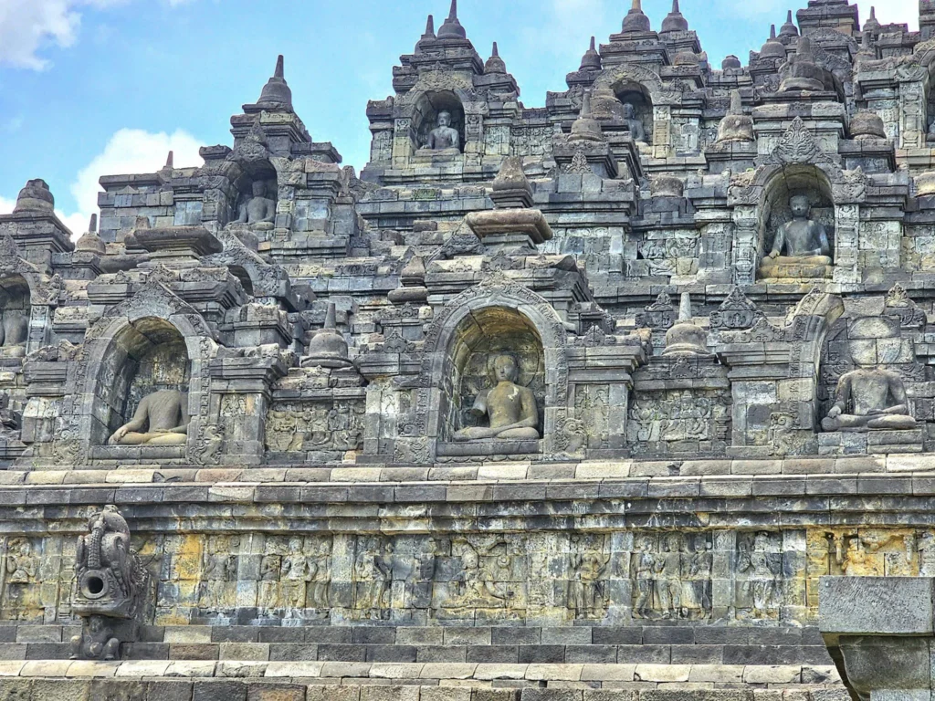 Cruising with Danny and Peter, Holland America Line, Westerdam, Semarang, Java, Indonesia, Borobudur Temple Cruise, Java Adventure | Panoramic view of Borobudur during a Borobudur Temple Cruise, showcasing the UNESCO Buddhist Temple amidst Central Java’s lush hills, with the Westerdam ship docked for the Holland America Westerdam Borobudur Tour, a Luxury Cruise Java adventure in Holland America Far East. Close-up of stupas and Buddha statues at Borobudur, reflecting Mahayana Buddhist Heritage, alongside a vibrant market scene from a Semarang Java Tour, part of an Indonesian Cultural Journey. Travelers explore this Borobudur Pilgrimage Site on a Central Java Travel excursion, enjoying a stunning sunset over the 9th-Century Temple Exploration, with detailed stone reliefs of the UNESCO Buddhist Temple and relaxation on the Westerdam deck during a Westerdam Cruise Indonesia.