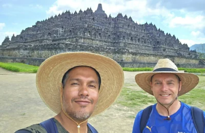 Cruising with Danny and Peter, Holland America Line, Westerdam, Semarang, Java, Indonesia, Borobudur Temple Cruise, Java Adventure | Panoramic view of Borobudur during a Borobudur Temple Cruise, showcasing the UNESCO Buddhist Temple amidst Central Java’s lush hills, with the Westerdam ship docked for the Holland America Westerdam Borobudur Tour, a Luxury Cruise Java adventure in Holland America Far East. Close-up of stupas and Buddha statues at Borobudur, reflecting Mahayana Buddhist Heritage, alongside a vibrant market scene from a Semarang Java Tour, part of an Indonesian Cultural Journey. Travelers explore this Borobudur Pilgrimage Site on a Central Java Travel excursion, enjoying a stunning sunset over the 9th-Century Temple Exploration, with detailed stone reliefs of the UNESCO Buddhist Temple and relaxation on the Westerdam deck during a Westerdam Cruise Indonesia.