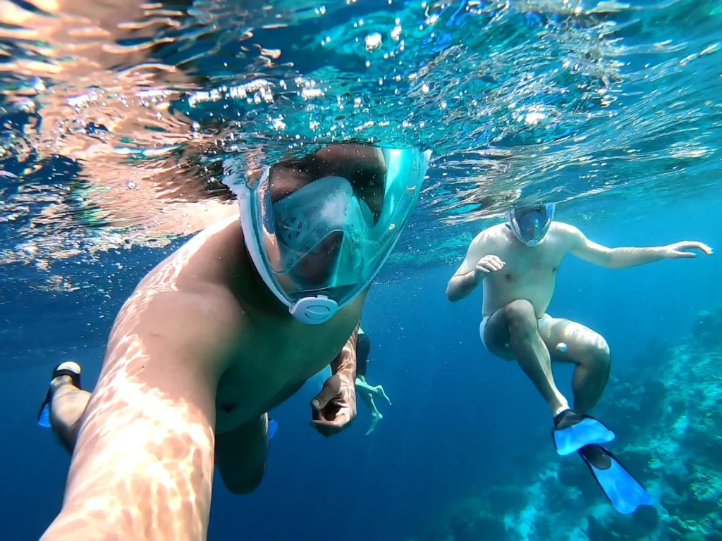 Cruising with Danny and Peter, Holland America Line, Zuiderdam, Kralendijk, Bonaire | A vibrant underwater scene showcasing colorful coral reefs and diverse marine life during a snorkeling adventure in Kralendijk, Bonaire, with tropical waters inviting exploration.