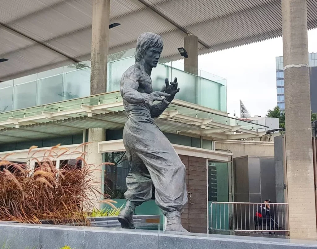 Cruising with Danny and Peter, Holland America Line, Westerdam, Hong Kong, China | A vibrant street in Kun Tong District, Hong Kong, showcasing colorful street art and local markets filled with fresh produce, reflecting the unique blend of traditional and modern Hong Kong culture, highlighting the culinary delights and bustling atmosphere of this captivating neighborhood.