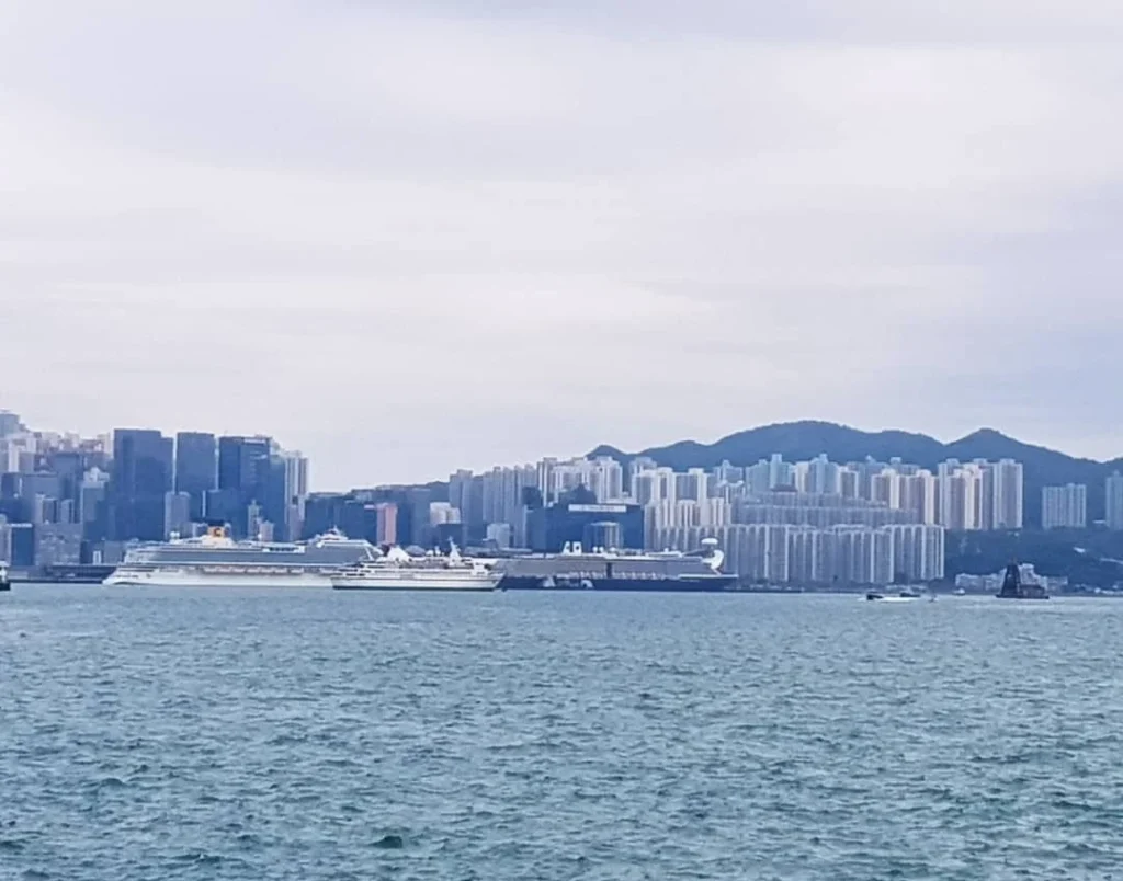 Cruising with Danny and Peter, Holland America Line, Westerdam, Hong Kong, China | A vibrant street in Kun Tong District, Hong Kong, showcasing colorful street art and local markets filled with fresh produce, reflecting the unique blend of traditional and modern Hong Kong culture, highlighting the culinary delights and bustling atmosphere of this captivating neighborhood.