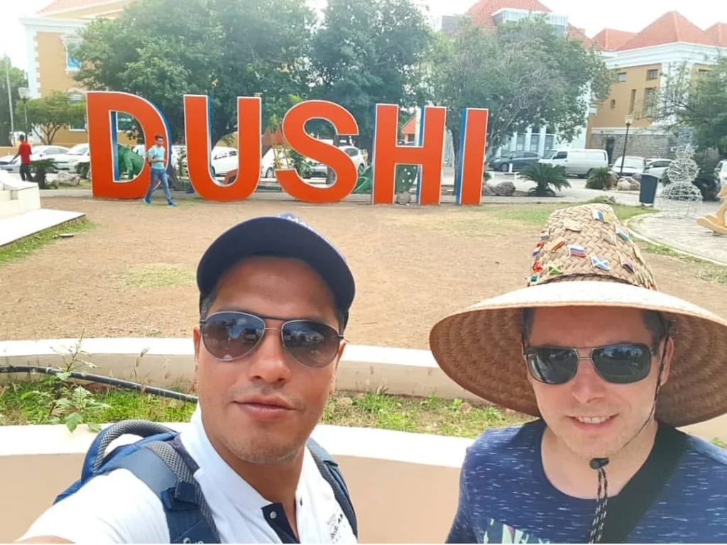 Cruising with Danny and Peter, Holland America Line, Zuiderdam, Willemstad, Curacao | Pristine sandy beach and turquoise waters at Wet & Wild Beach Club in Willemstad, Curaçao, featuring snorkeling enthusiasts exploring vibrant coral reefs, thrilling water sports like jet skiing and parasailing, and a spectacular sunset view from the beachfront bar, showcasing the ultimate Caribbean beach resort experience.