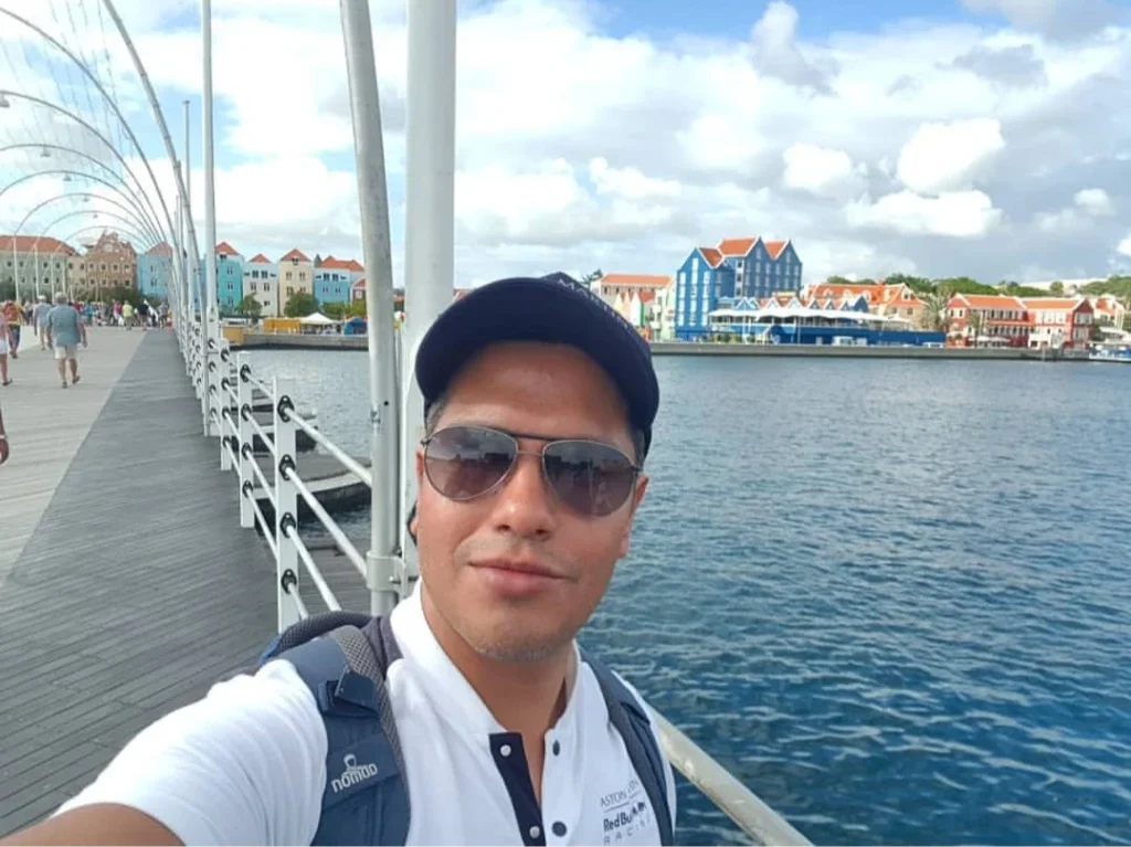 Cruising with Danny and Peter, Holland America Line, Zuiderdam, Willemstad, Curacao | Pristine sandy beach and turquoise waters at Wet & Wild Beach Club in Willemstad, Curaçao, featuring snorkeling enthusiasts exploring vibrant coral reefs, thrilling water sports like jet skiing and parasailing, and a spectacular sunset view from the beachfront bar, showcasing the ultimate Caribbean beach resort experience.