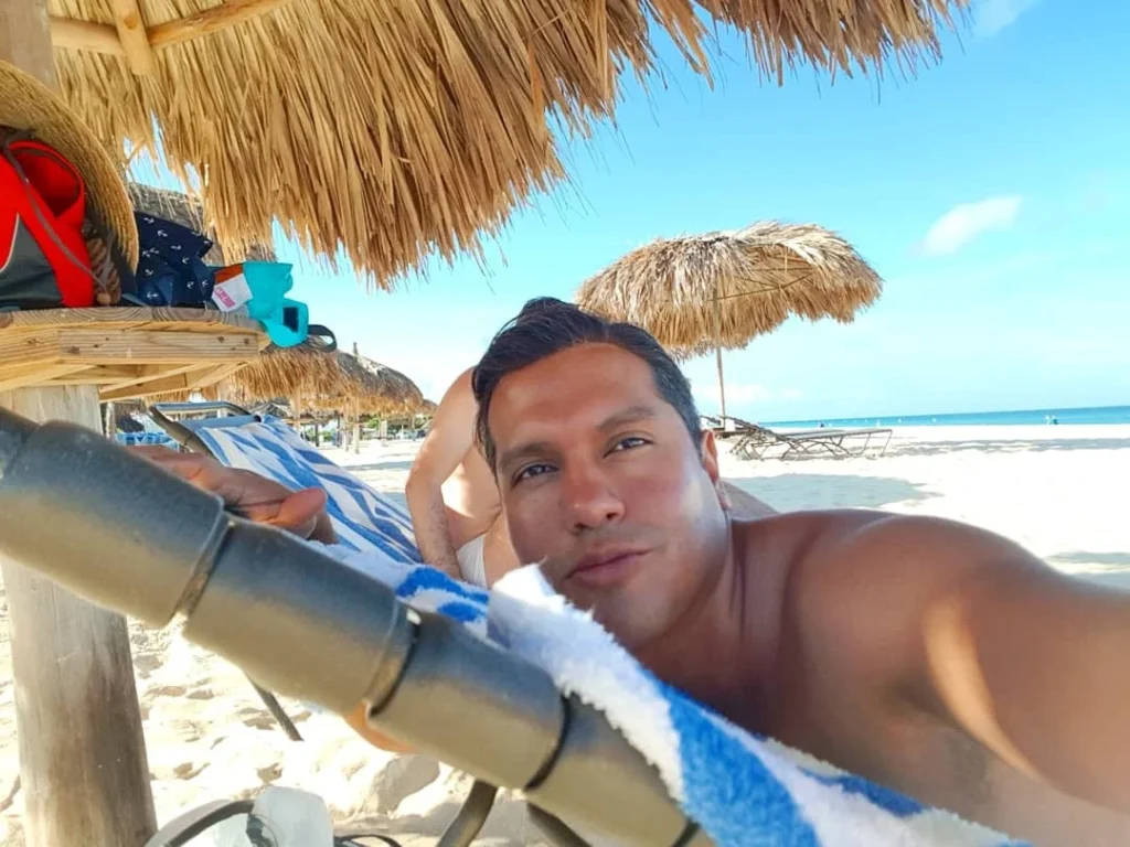 Cruising with Danny and Peter, Holland America Line, Zuiderdam, Oranjestad, Aruba | Vibrant view of Oranjestad Beach with powdery sands and turquoise waters during a relaxing beach day in Aruba, showcasing local beachfront dining and coastal activities.