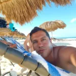 Cruising with Danny and Peter, Holland America Line, Zuiderdam, Oranjestad, Aruba | Vibrant view of Oranjestad Beach with powdery sands and turquoise waters during a relaxing beach day in Aruba, showcasing local beachfront dining and coastal activities.