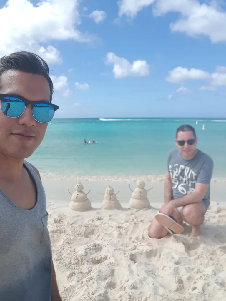 Cruising with Danny and Peter, Holland America Line, Zuiderdam, Oranjestad, Aruba | Vibrant view of Oranjestad Beach with powdery sands and turquoise waters during a relaxing beach day in Aruba, showcasing local beachfront dining and coastal activities.