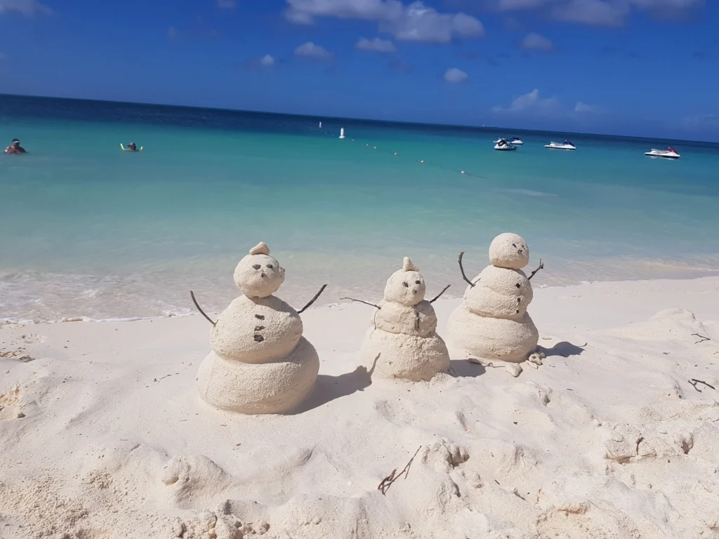 Cruising with Danny and Peter, Holland America Line, Zuiderdam, Oranjestad, Aruba | Vibrant view of Oranjestad Beach with powdery sands and turquoise waters during a relaxing beach day in Aruba, showcasing local beachfront dining and coastal activities.