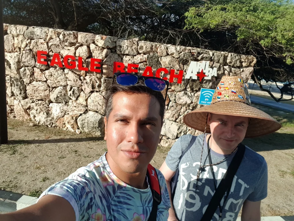 Cruising with Danny and Peter, Holland America Line, Zuiderdam, Oranjestad, Aruba | Vibrant view of Oranjestad Beach with powdery sands and turquoise waters during a relaxing beach day in Aruba, showcasing local beachfront dining and coastal activities.