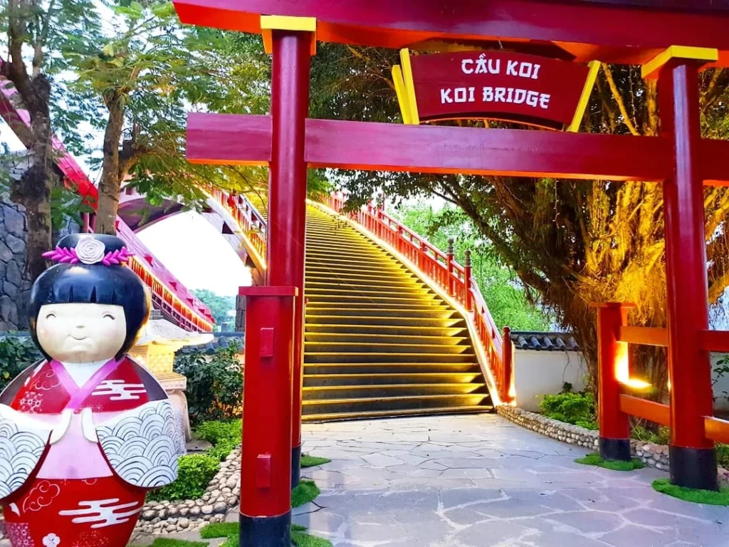 Cruising with Danny and Peter, Holland America Line, Westerdam, Halong Bay, Vietnam | A stunning view of the Hạ Long Bay Yacht cruising through emerald waters, surrounded by majestic limestone karsts. Guests enjoy Vietnamese seafood dining on the deck while kayaking in Hạ Long Bay. The private yacht tour showcases the beauty of this UNESCO World Heritage site.