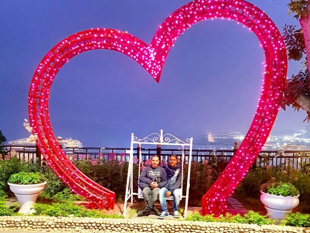 Cruising with Danny and Peter, Holland America Line, Westerdam, Halong Bay, Vietnam | A stunning view of the Hạ Long Bay Yacht cruising through emerald waters, surrounded by majestic limestone karsts. Guests enjoy Vietnamese seafood dining on the deck while kayaking in Hạ Long Bay. The private yacht tour showcases the beauty of this UNESCO World Heritage site.