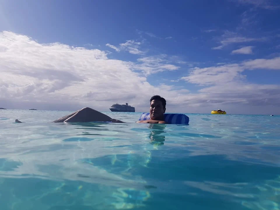 Tranquil Bliss: A Day at Half Moon Cay 4 Cruising with Danny and Peter, Holland America Line, Nieuw Amsterdam, Half Moon Cay, Bahamas | A serene day at Half Moon Cay Bahamas showcasing a tranquil beach escape with crystal-clear waters, soft ivory sands, tropical island views, lush greenery, and vibrant coral reefs ideal for snorkeling, capturing the essence of a private island Bahamas retreat in a pristine Caribbean paradise.