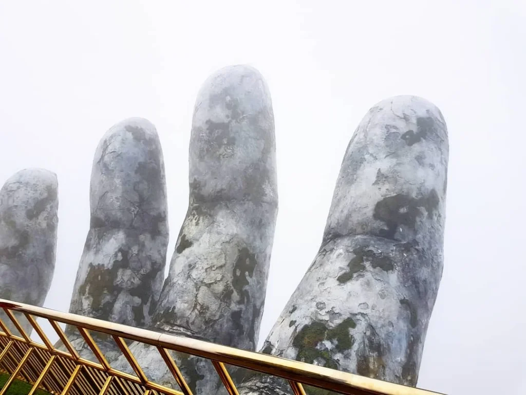 Cruising with Danny and Peter, Holland America Line, Westerdam, Da Nang, Hue, Vietnam | Stunning views of Bana Hills Marble Mountains in Vietnam, featuring the iconic Golden Bridge held by giant stone hands, the charming French Village, and serene Vietnamese Buddhist sanctuaries nestled within the lush limestone hills.