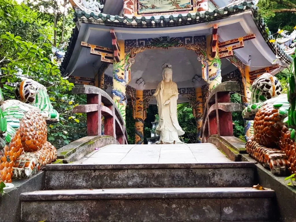 Cruising with Danny and Peter, Holland America Line, Westerdam, Da Nang, Hue, Vietnam | Stunning views of Bana Hills Marble Mountains in Vietnam, featuring the iconic Golden Bridge held by giant stone hands, the charming French Village, and serene Vietnamese Buddhist sanctuaries nestled within the lush limestone hills.