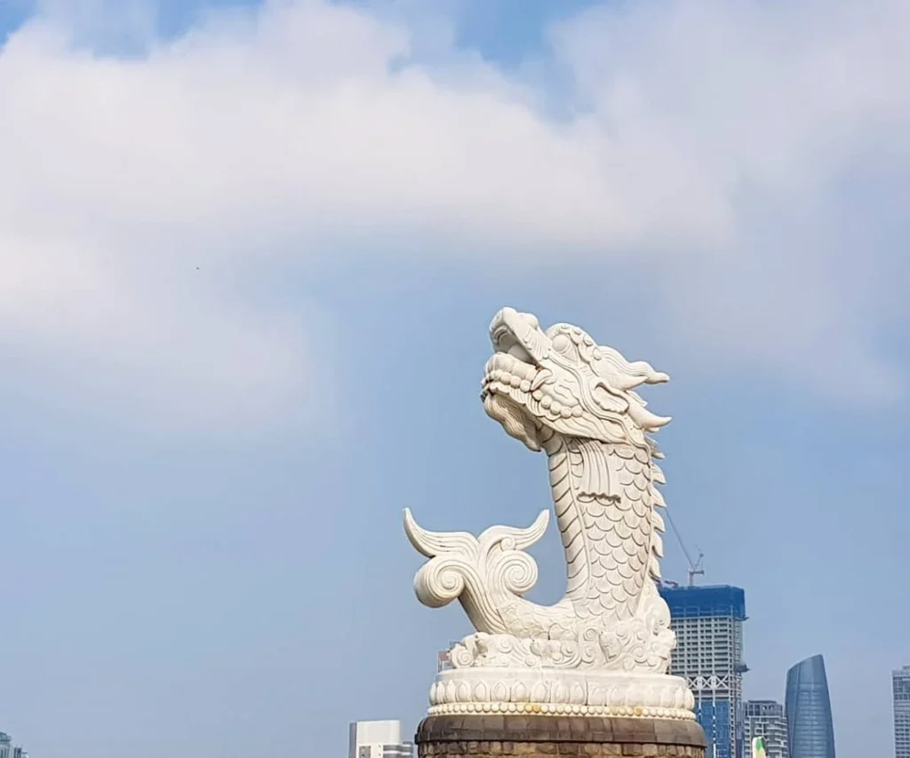 Cruising with Danny and Peter, Holland America Line, Westerdam, Da Nang, Hue, Vietnam | A vibrant street scene in Đà Nẵng showcasing a bustling market filled with fresh produce and aromatic spices, capturing the essence of Vietnamese cuisine. Motorbikes are parked nearby, symbolizing the thrilling motorbike street food tour. An enticing plate of bánh mì and bowls of pho are featured prominently, representing the local street eats enjoyed during this culinary exploration.