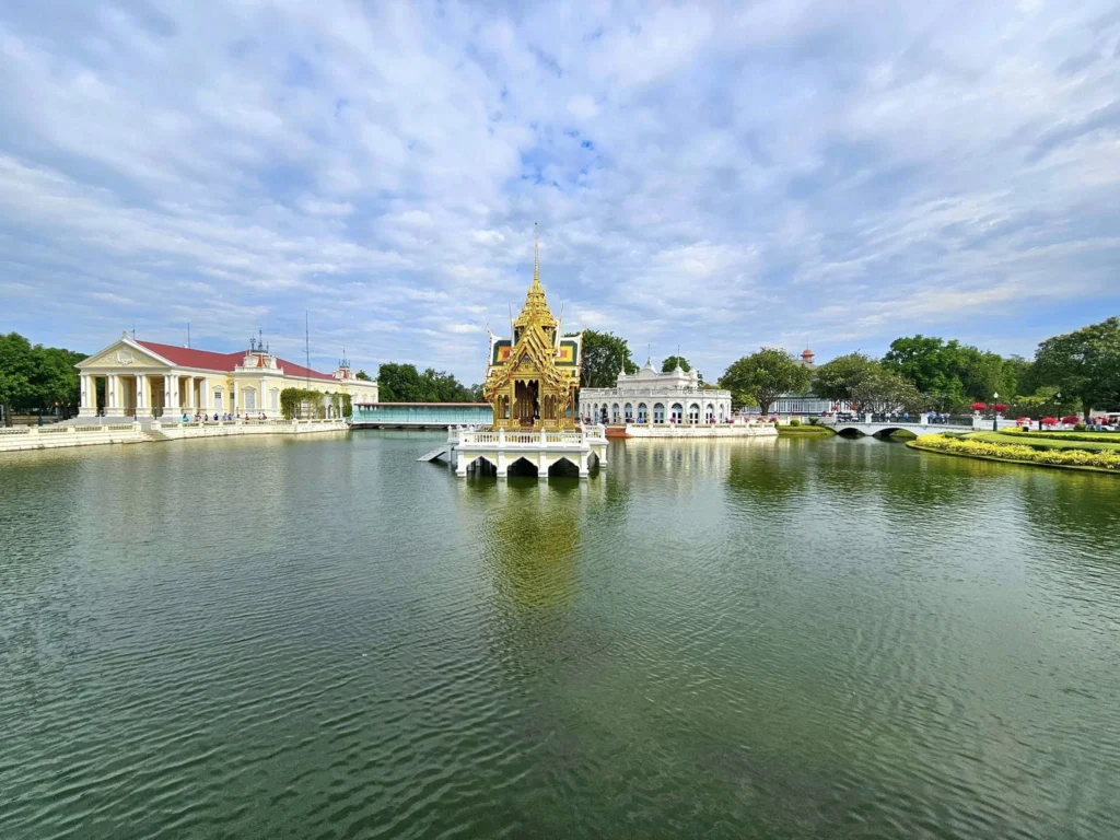 A Majestic Journey: Unveiling the Royal Historical Tour Ayutthaya from the Holland America Cruise 14 Cruising with Danny and Peter, Holland America Line, Westerdam, Laem Chabang, Bangkok, Thailand, Royal Historical Tour Ayutthaya 5 Glorious Stops | Exploring the Royal Historical Tour Ayutthaya and Bang Pa In Ayutthaya with lush gardens at Bang Pa In Palace, the elegant Aisawan Dhipaya Pavilion on a tranquil lake, towering stupa and Buddha statues at Ayutthaya Temples, colorful Traditional Thai Cuisine, and the iconic Buddha head in tree roots at Wat Mahathat Ruins—a UNESCO Heritage Site—all part of an unforgettable Thailand Cultural Tour and Ayutthaya Day Trip from the Holland America Cruise, showcasing Thai Royal History.